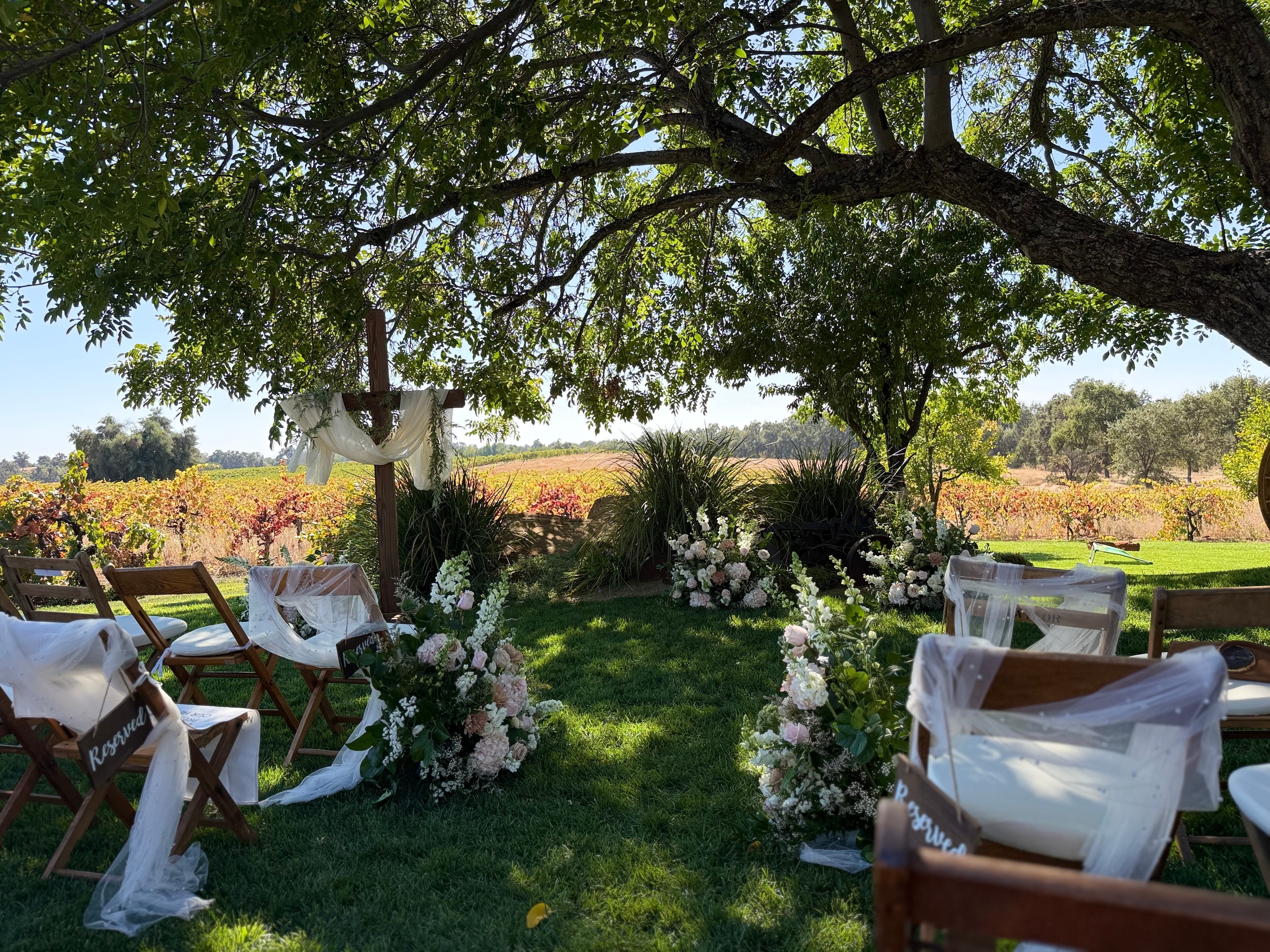 Farm tables set for an outdoor wedding