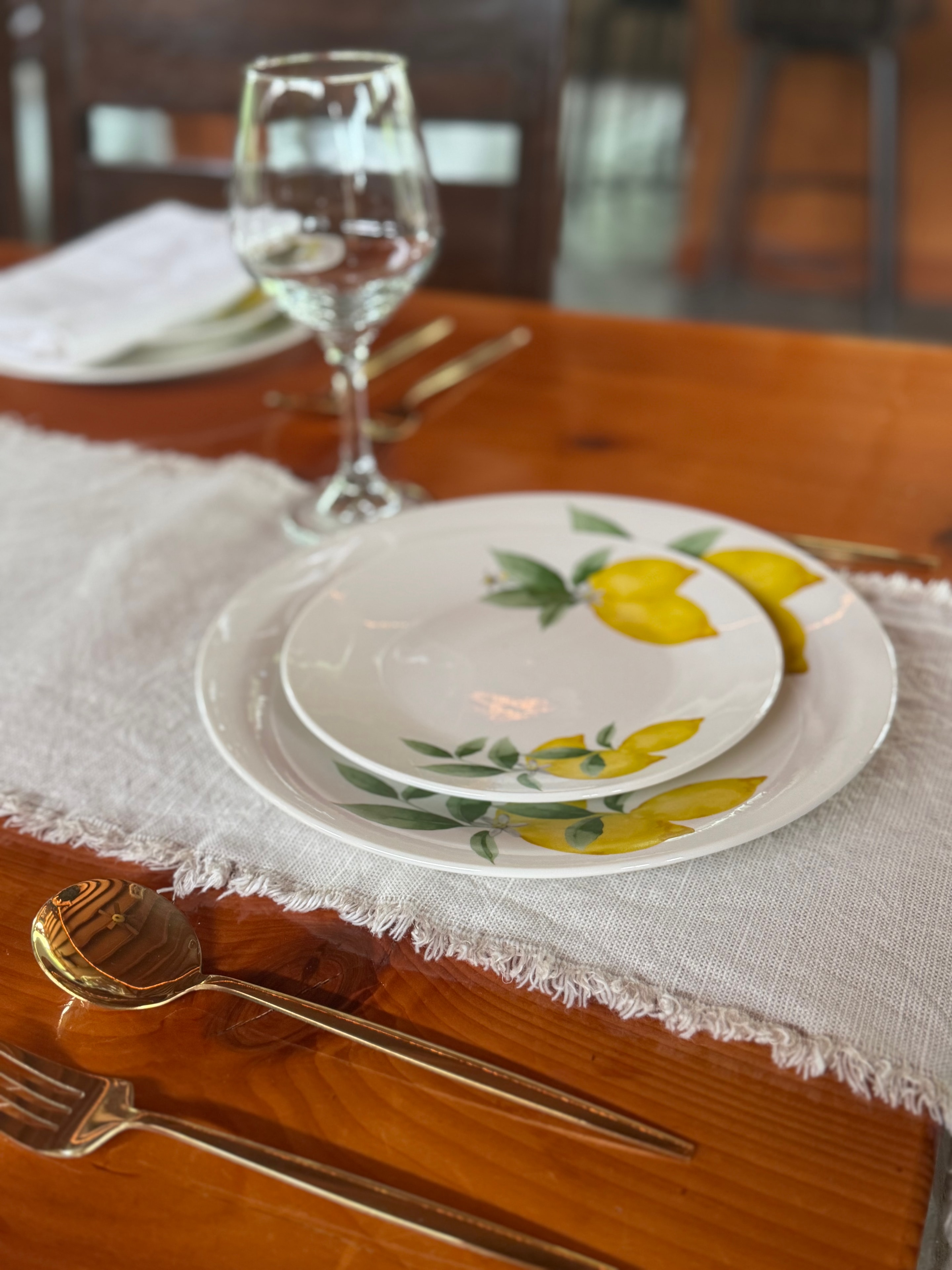 Lemon china place setting with gold flatware